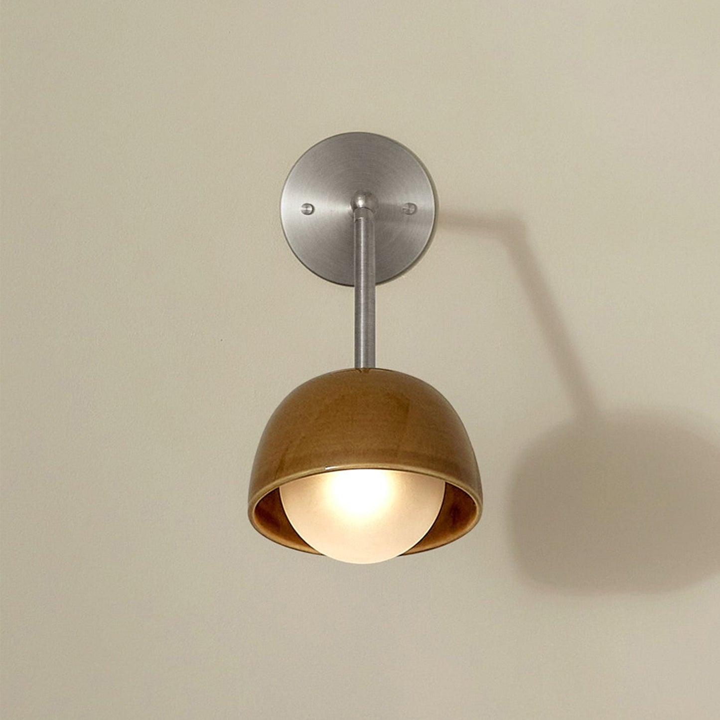 Marz Designs Terra 0 Long Wall Light articulating sconce in Chartreuse ceramic and Brushed Nickel hardware, folded flush against a wall.