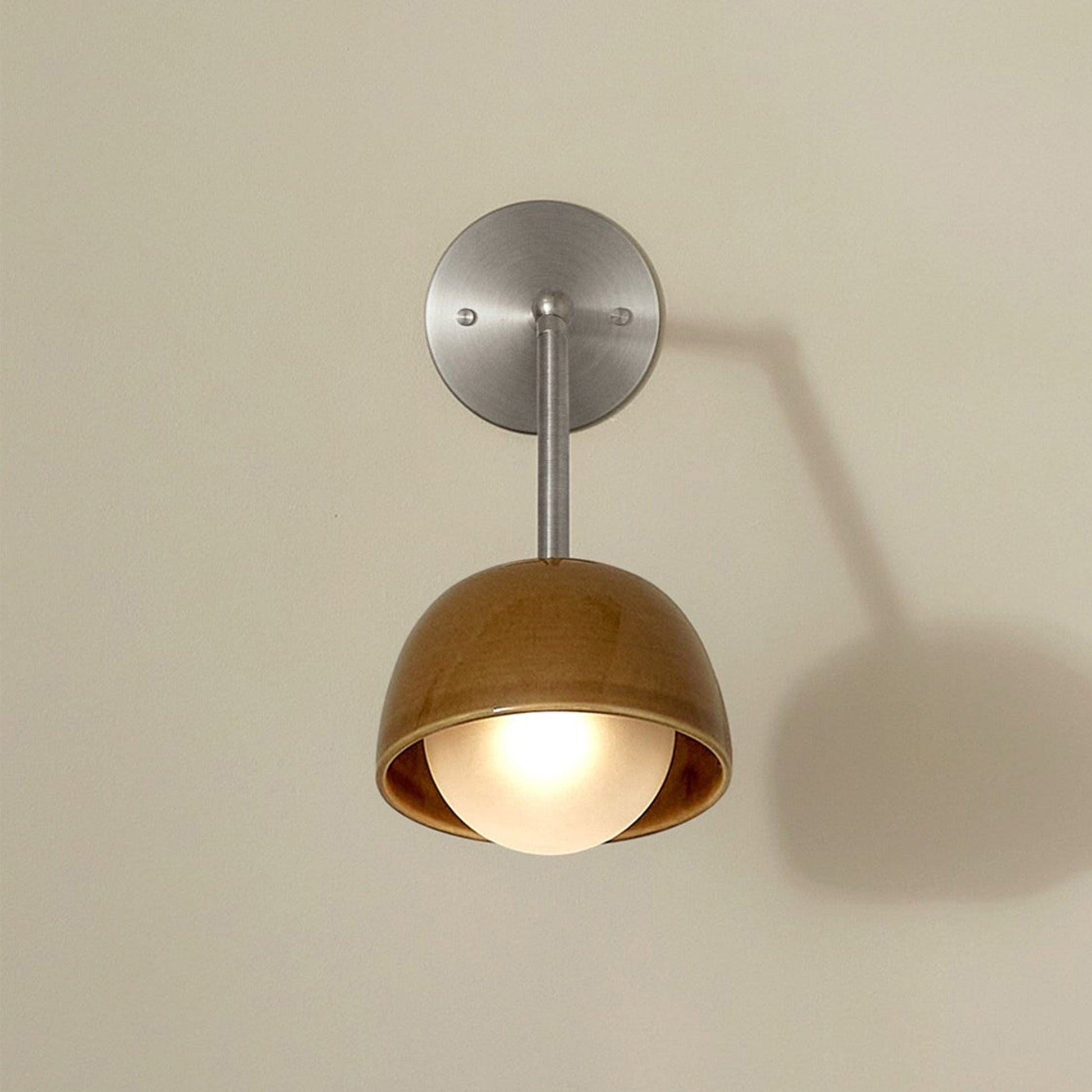 Marz Designs Terra 0 Long Wall Light articulating sconce in Chartreuse ceramic and Brushed Nickel hardware, folded flush against a wall.