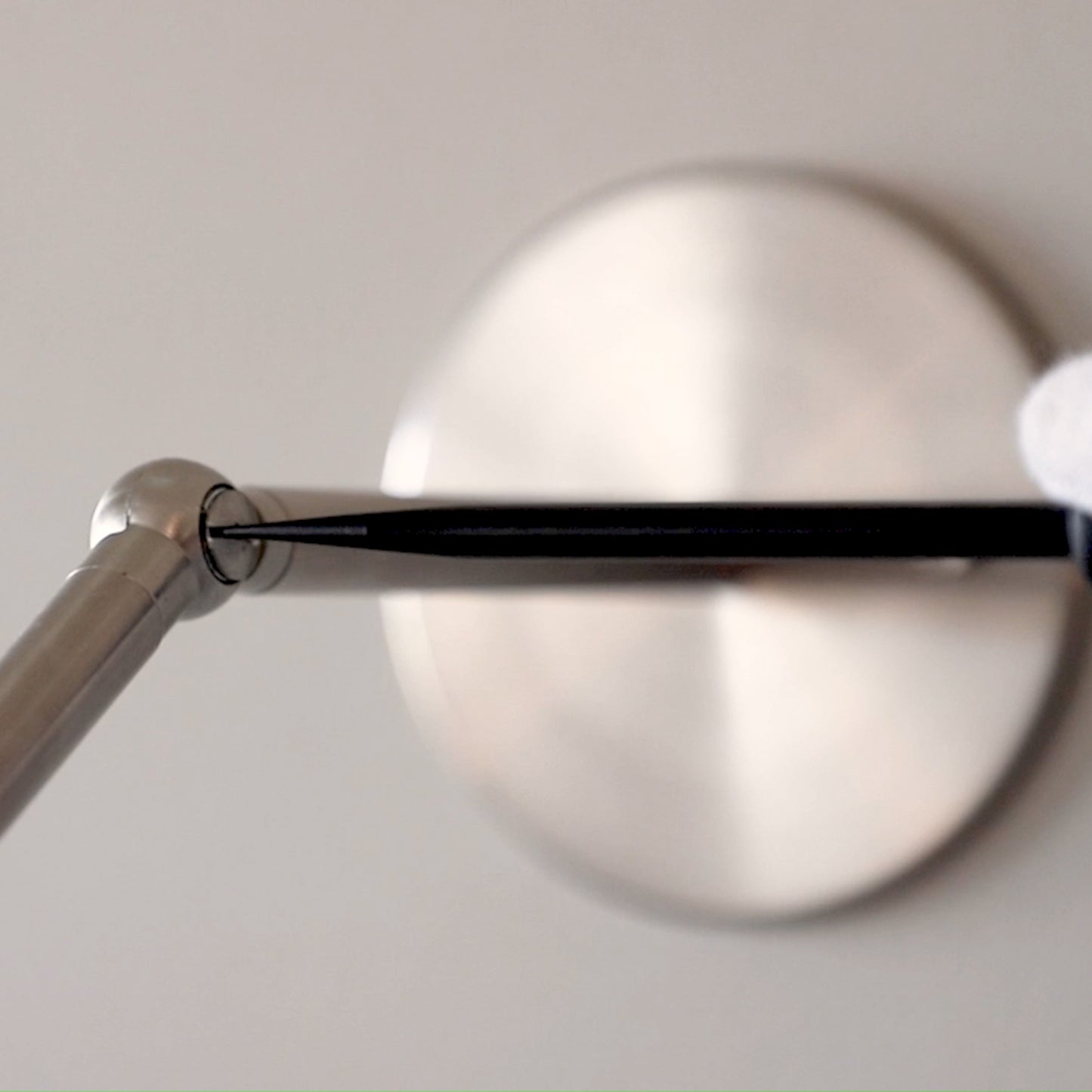 Close-up detail of the adjustable pivot joint and metal hardware on the Marz Designs Terra 0 Long Wall Light.