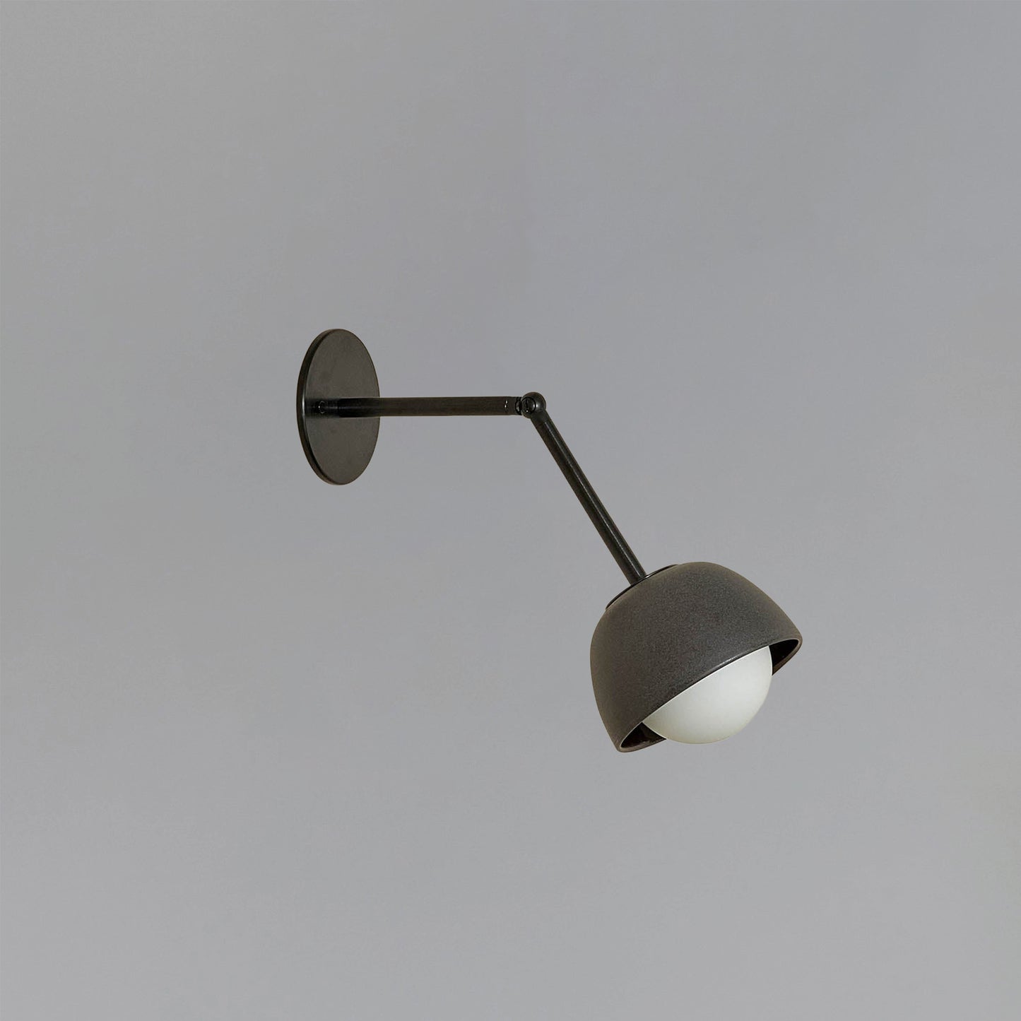 Marz Designs Terra 0 Long Wall Light articulating sconce in Lead ceramic and Brushed Black hardware.