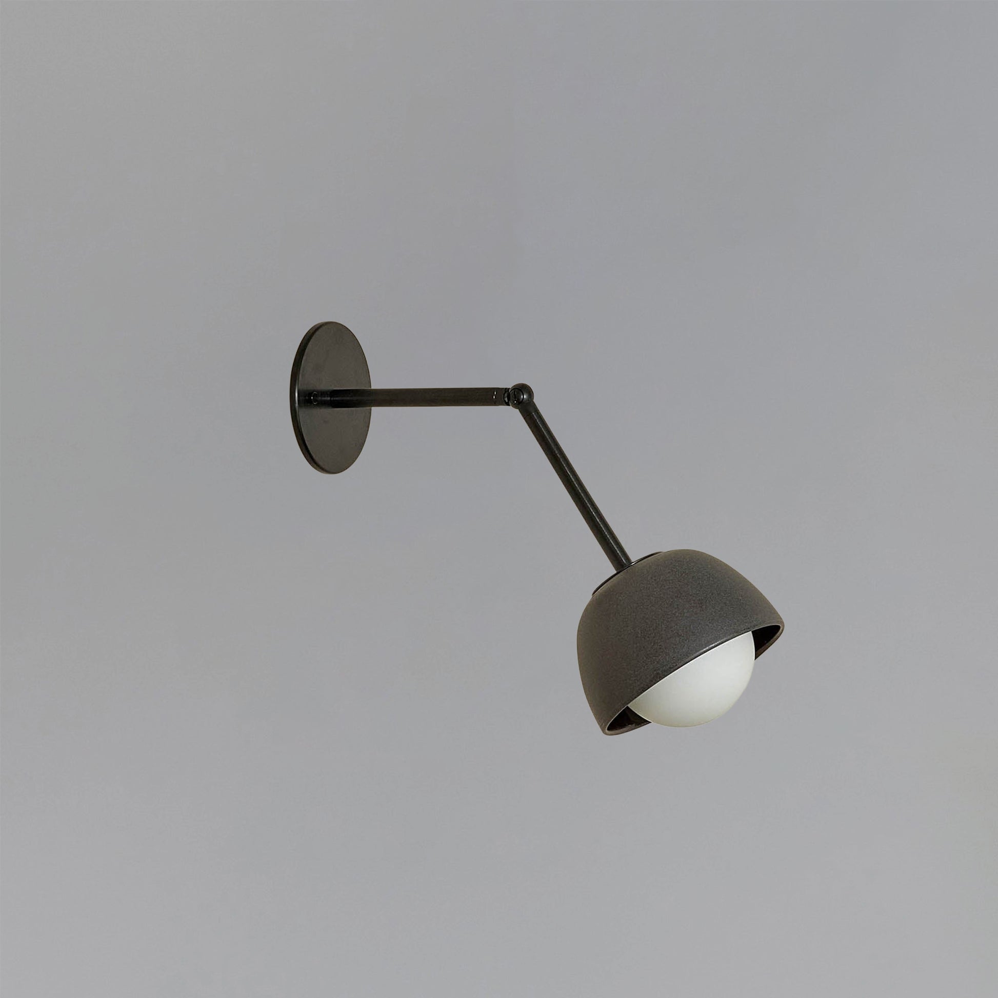 Marz Designs Terra 0 Long Wall Light articulating sconce in Lead ceramic and Brushed Black hardware.