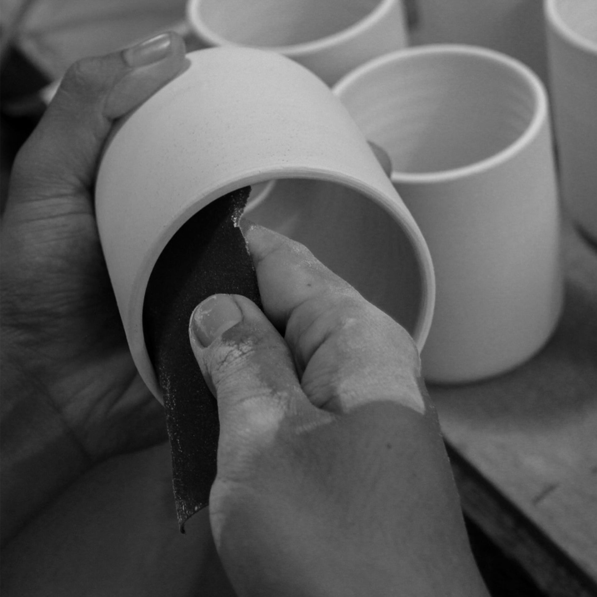 Hand-finishing the wheel-turned ceramic shade for the Marz Designs Terra 1 Pendant.