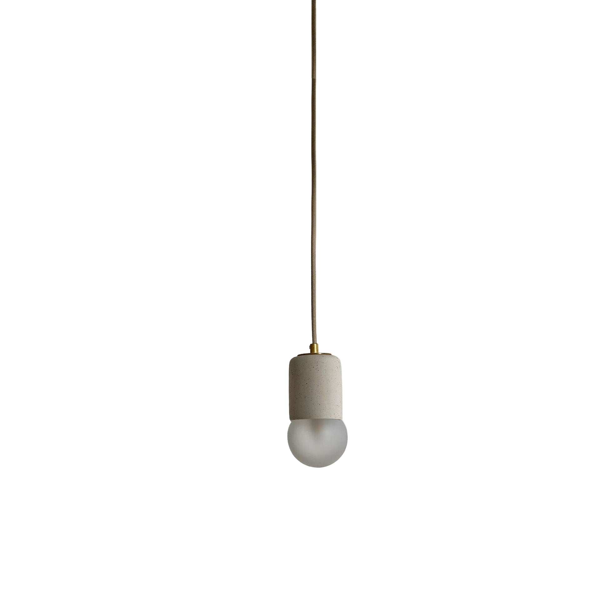 Marz Designs Terra 1 Pendant in Vanilla ceramic and Brass hardware with fabric flex cord and frosted glass.